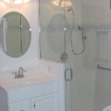 Bathroom Remodel - A fully wheelchair accessible bathroom with comfort height toilet.  Multiple grab bars, two oversized entry doors with lever handles and a no curb shower with shampoo niche including fixed shower head and handheld.