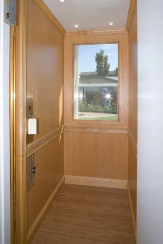 Accessible home remodel featuring elevator with window.